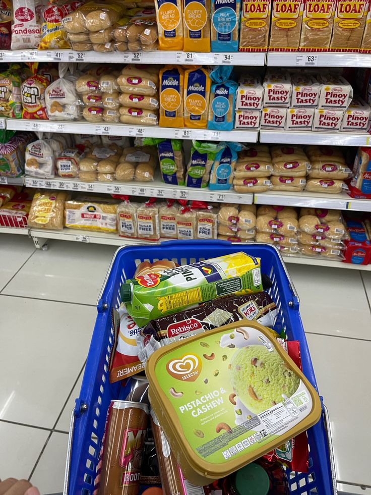 a shopping cart filled with food in a store