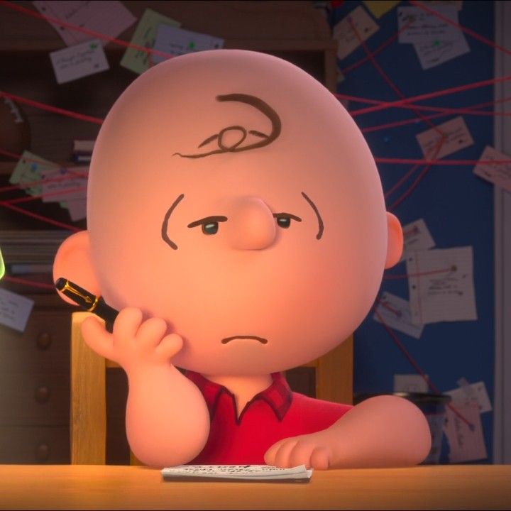 a cartoon character sitting at a desk with a cell phone in his hand and looking to the side