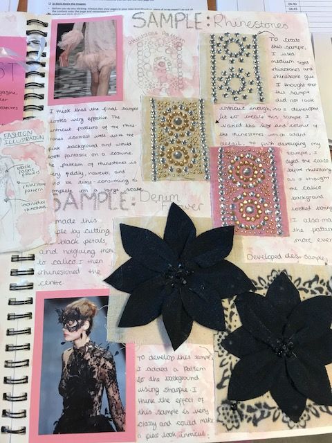 an open book with pictures and flowers on the pages, including some black felt poinsettis