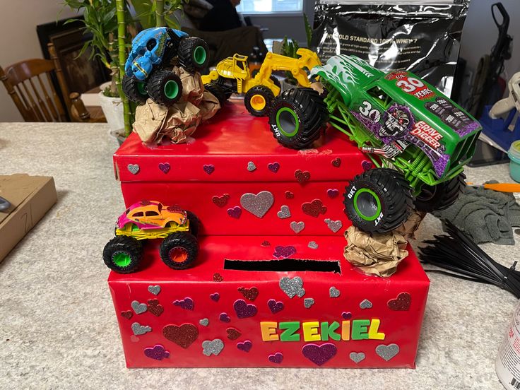 three toy trucks are stacked on top of each other