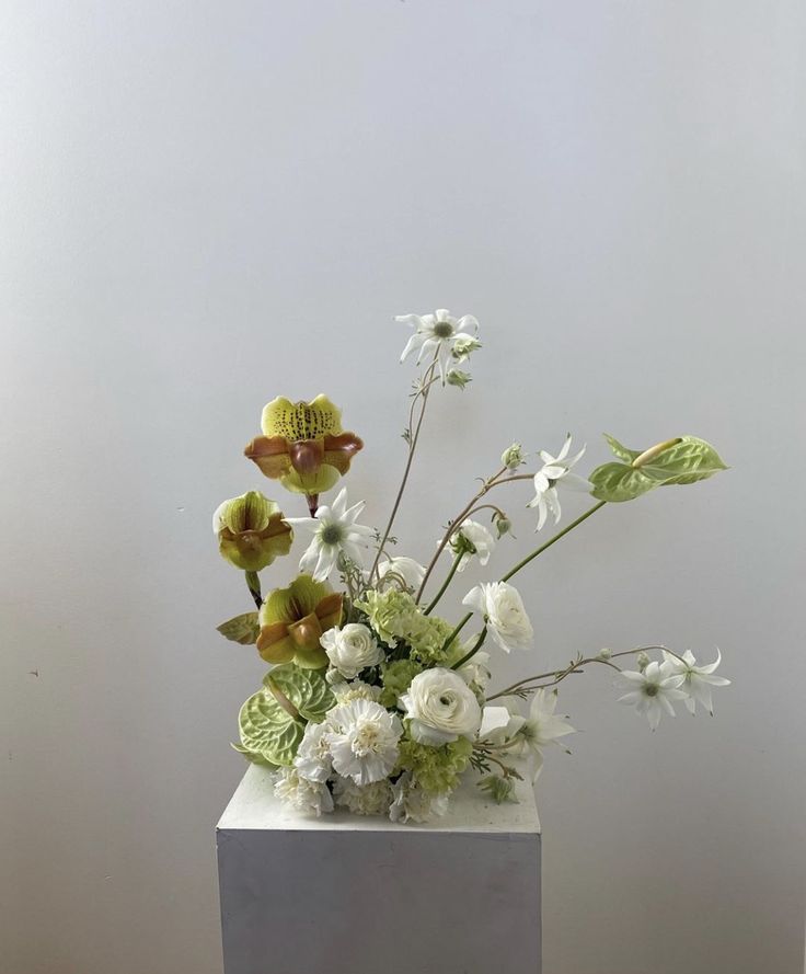 a vase filled with white and green flowers