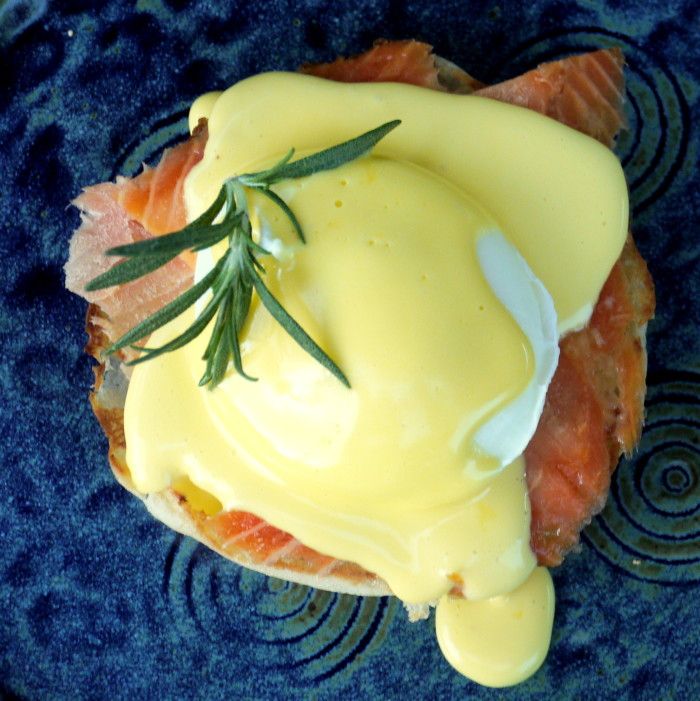 a blue plate topped with salmon and hollandaise