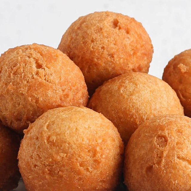 a pile of doughnuts sitting on top of a white countertop next to each other