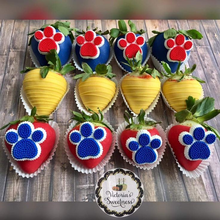 the strawberries are decorated with red, white and blue decorations that include paw prints