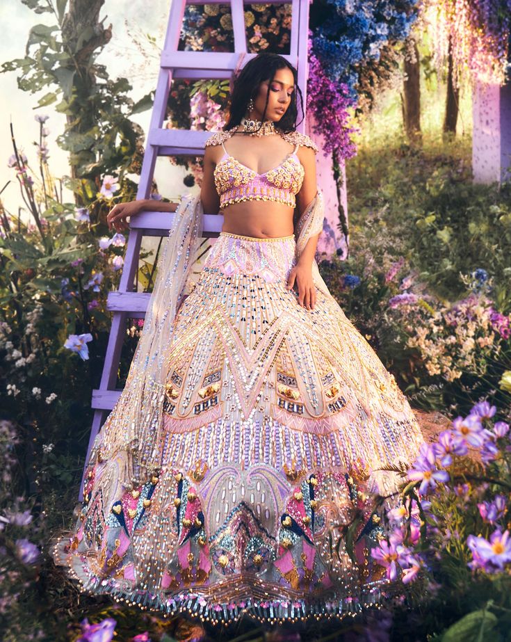 a woman standing in front of a purple ladder wearing a white and pink outfit with butterflies on it