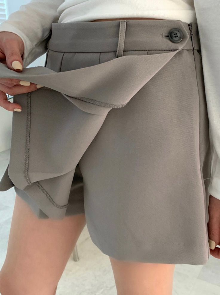 Details This skort is featured in low rise, pleats with pants inside. ● Pleats with wrapped ● Side zipper ● Pants inside ● Low rise Care Hand Wash Cold Model size 5'2" waist (25"-26") model is wearing S Product Info Size: S, M Color: Beige, Grey, Black Fabric: 97% polyester, 3% spandex [Our Policy] Exchange/refund are available within 7 days after receiving the product(s). Exchange/refund are not available for any worn product(s) or products damaged by customers. Please understand ivory and whit High Waist Solid Pleated Shorts, Solid High Waist Pleated Shorts, Chic Short Pleated Bottoms, Solid Short Pleated Bottoms, Solid Pleated Shorts, Trendy Pleated Bottoms With Short Inseam, Spring Pleated Bottoms With Short Inseam, Trendy Pleated Bottoms, Trendy Pleated Shorts