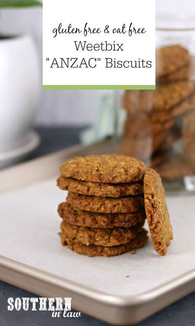 a stack of cookies sitting on top of a metal tray next to a glass jar