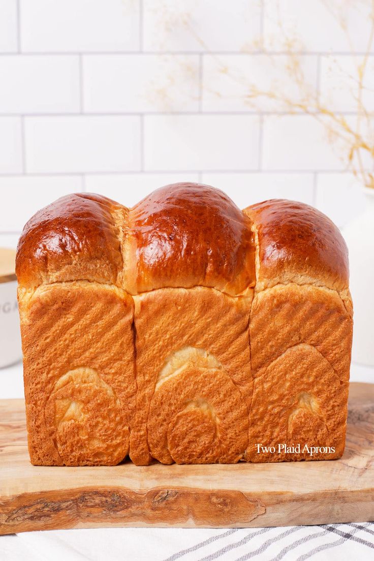 a loaf of bread sitting on top of a wooden cutting board