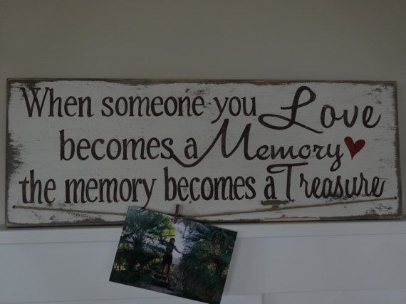 a wooden sign that says when someone you love becomes memory, the memory becomes a treasure