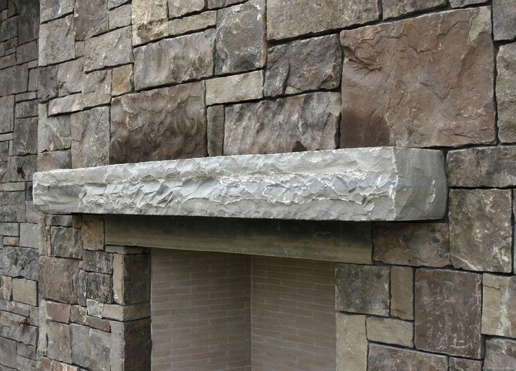 an old brick fireplace with a stone mantle