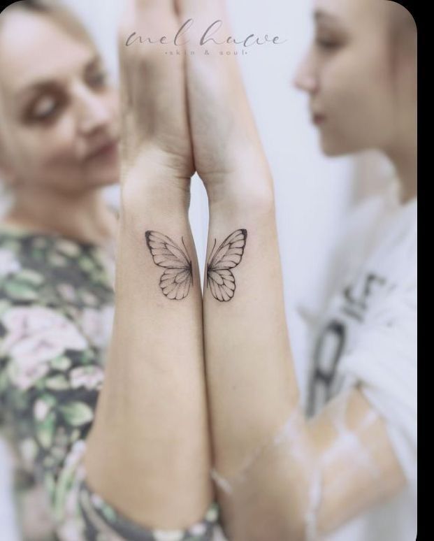 two women with matching tattoos on their arms