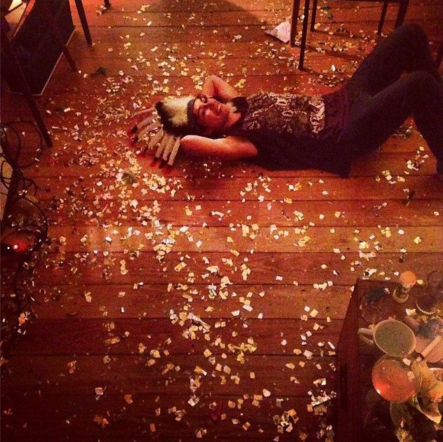 a woman laying on the floor with confetti all over her