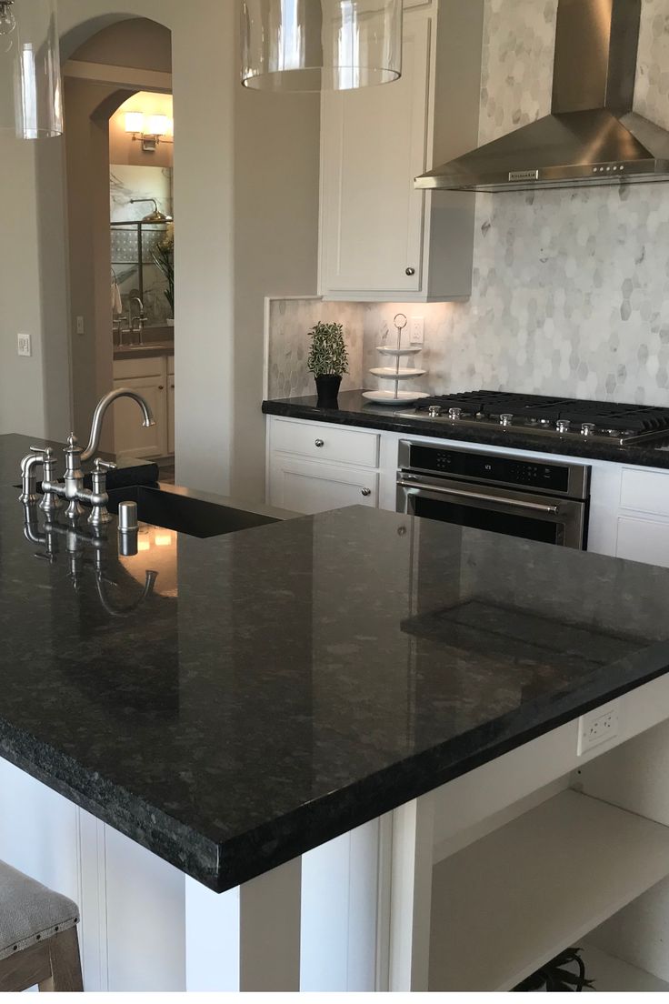 a kitchen with an island, stove and sink