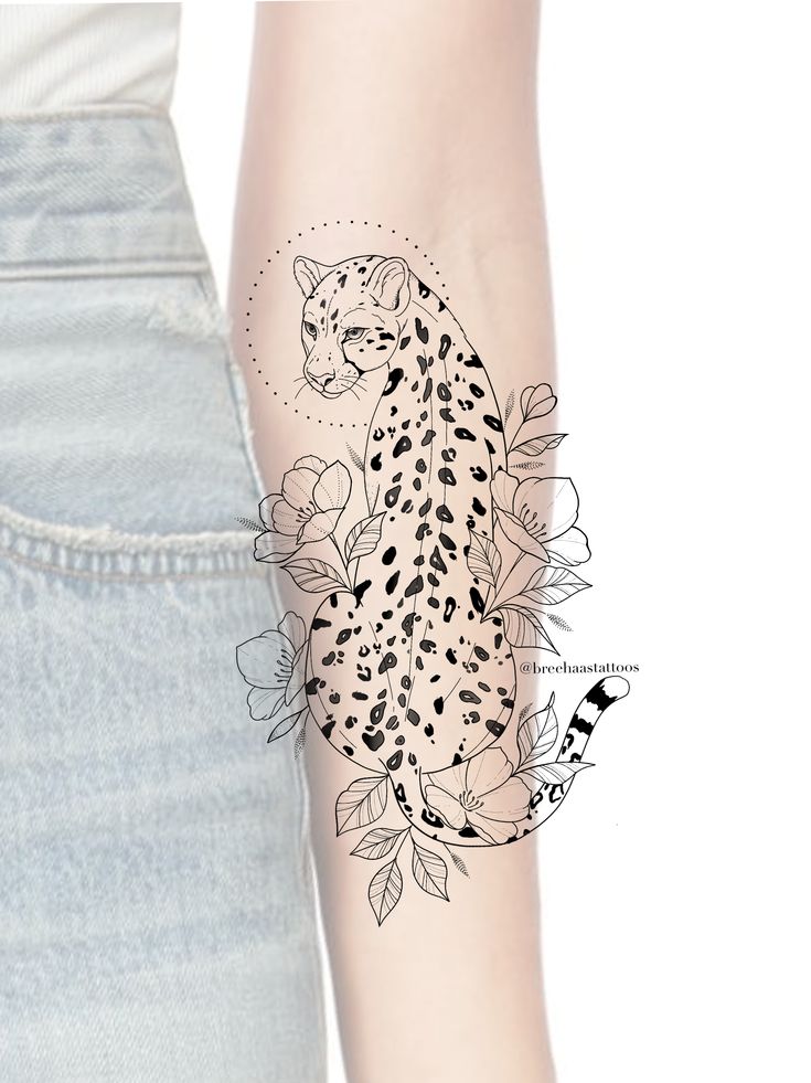 a woman's arm with a tattoo on it that has a cheetah