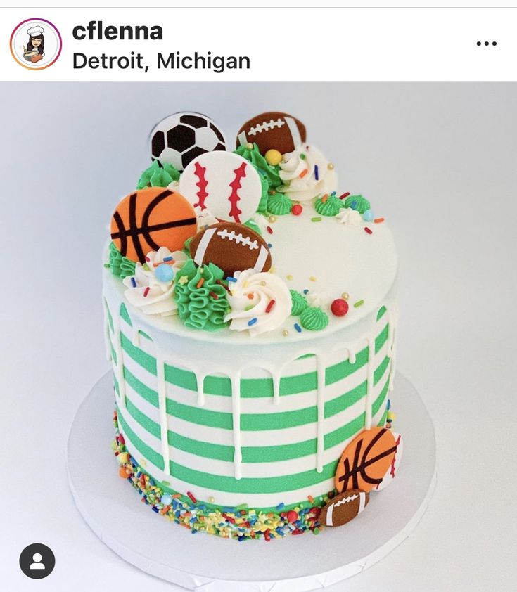 there is a cake decorated with sports balls on the top and green stripes around it