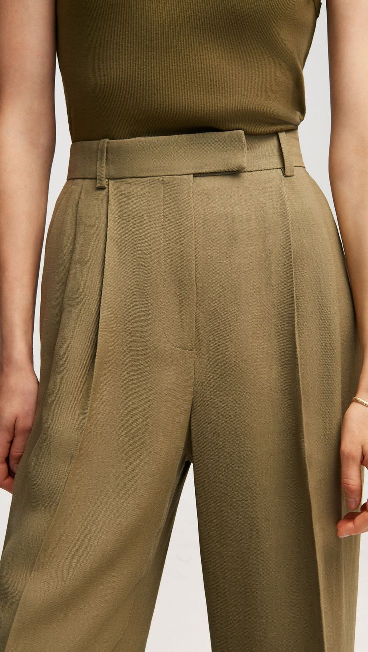 Our slouchy Pleated Trouser is a timeless piece that finds balance in touting both a wide-leg and a slim fit. The pant borrows from traditional suiting with a curtained waistband — which sits at the natural waistline for a flattering appearance — alongside pleated detailing. Timeless Wide Leg Pants For Workwear In Spring, Timeless Semi-formal Wide Leg Bottoms, Spring Classic Wide-leg Pantsuit, Classic Spring Wide-leg Pantsuit, Timeless Wide-leg Pants For Tailoring, Classic Wide-leg Spring Pantsuit, Timeless Wide-leg Tailored Pants, Timeless Wide Leg Tailored Pants, Timeless Tailored Wide Leg Pants