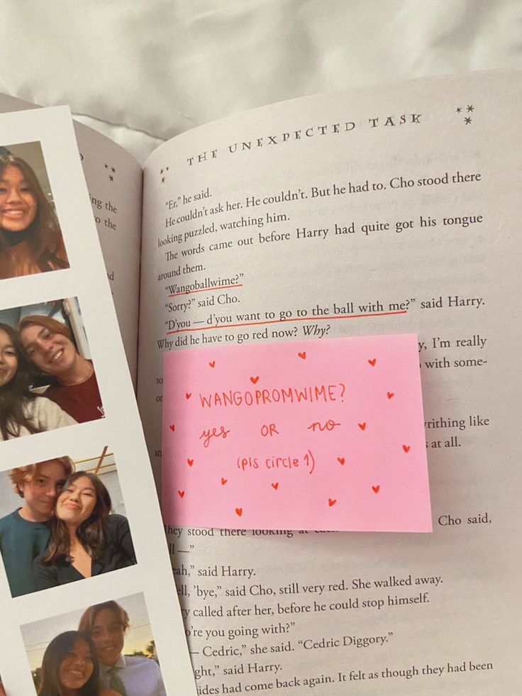 an open book with pictures on it and a pink sticky note attached to the page