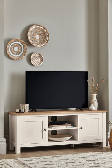 a flat screen tv sitting on top of a white entertainment center