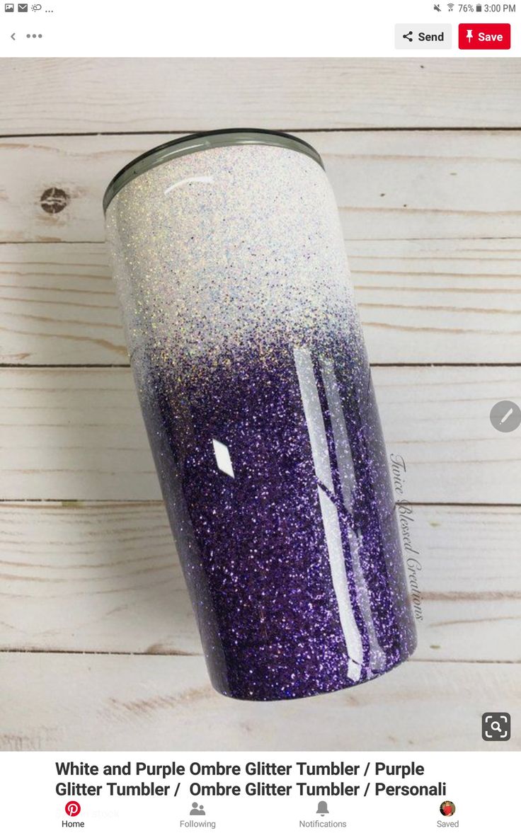 a purple and white glitter tumbler sitting on top of a wooden table next to a wall