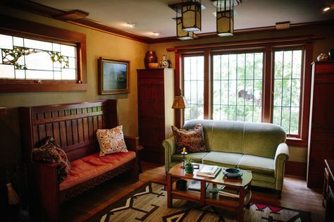 a living room filled with furniture and windows