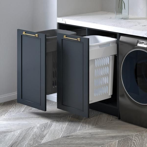 a washer and dryer in a kitchen with the door open to reveal it's contents