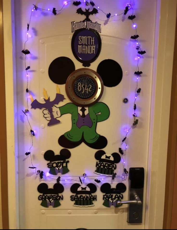 a door decorated with mickey mouse decorations and purple light garlands on the front door