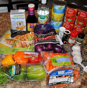 an assortment of food items sitting on top of a kitchen counter next to bottles of juice and seasonings