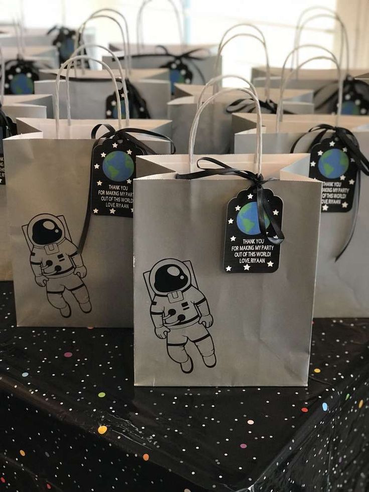 small bags with stickers on them sitting on top of a black and white table