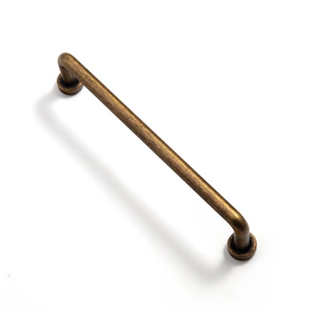 an antique brass cabinet pull handle on a white background with room for text or image