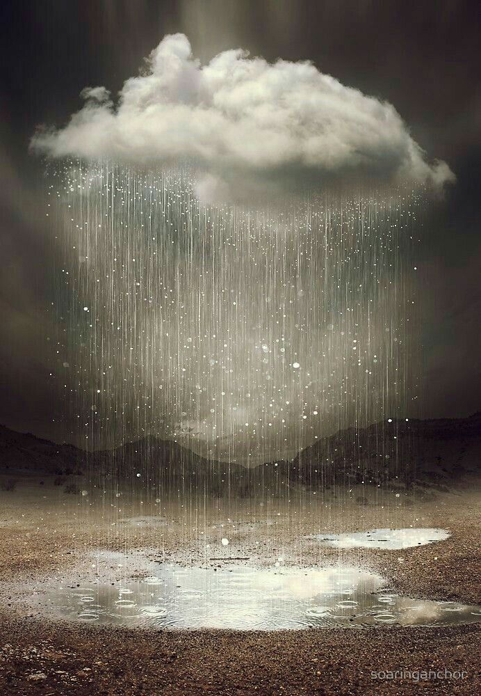 an image of rain falling down from the sky over a puddle of water and mountains