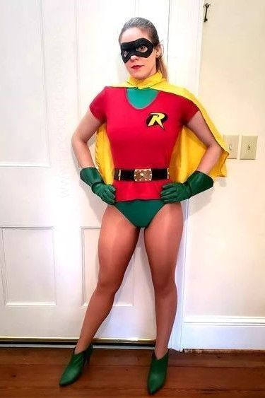 a woman in a costume standing next to a door with her hands on her hips