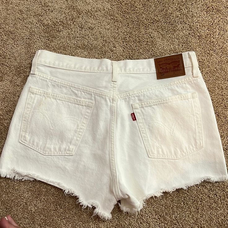 White Levi’s Jean Shorts, Never Worn!! Fits Large White Levi's Cotton Bottoms, Levi's White Cotton Bottoms, White Cotton Levi's Bottoms, Cutoff Cotton Bottoms For Vacation, Cutoff Shorts With Pockets For Vacation, Cotton Cutoff Bottoms For Vacation, White Relaxed Fit Jean Shorts For Summer, Levi's White Casual Shorts, Cutoff Bottoms With Pockets For Vacation