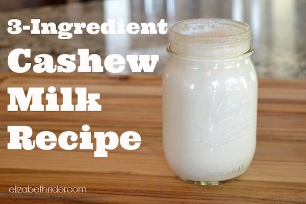 a mason jar filled with milk sitting on top of a wooden table