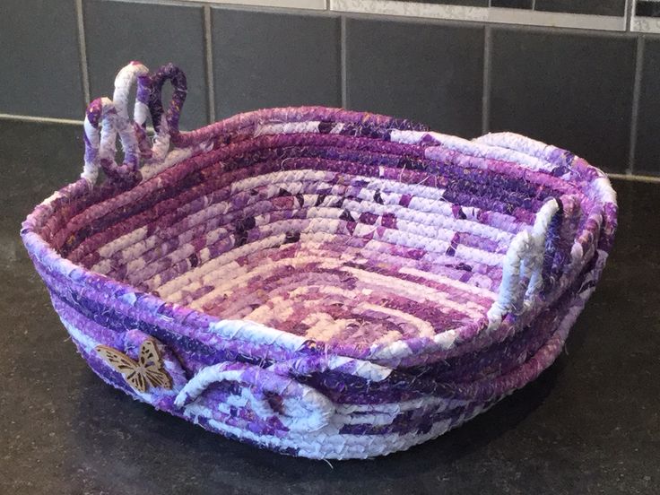 a purple and white basket sitting on top of a counter