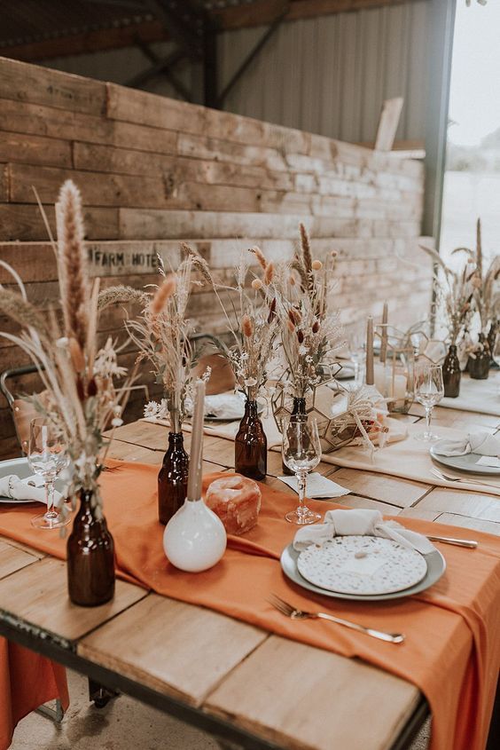 the table is set with plates and vases