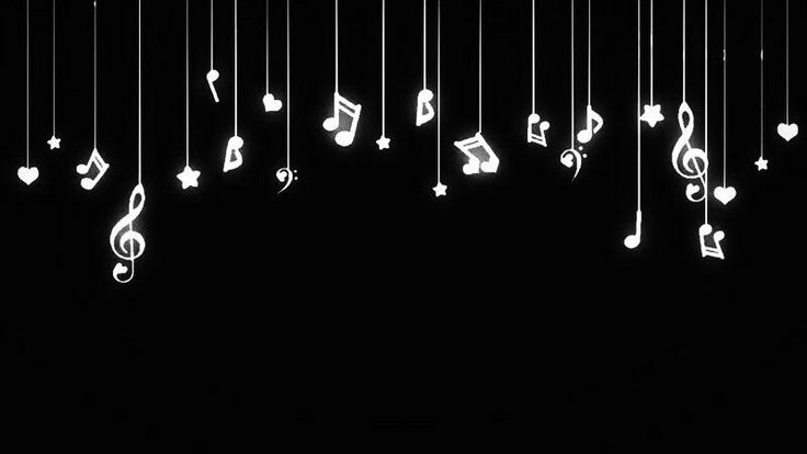 musical notes and hearts hanging from strings in the dark, with white lights shining down on them