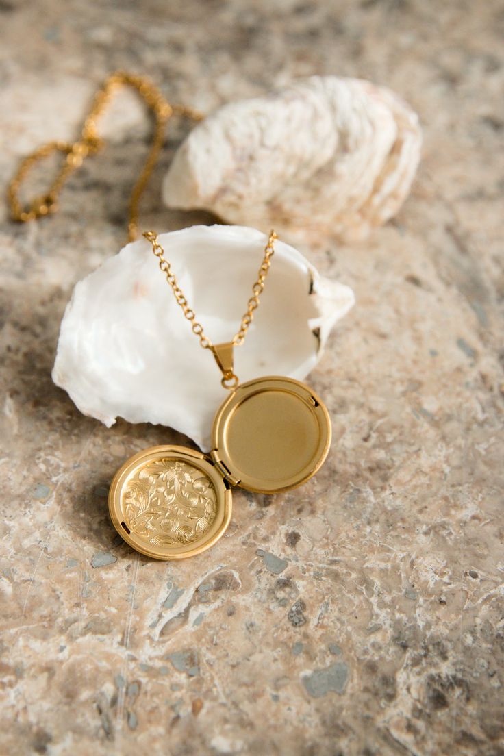 Our Lyon Locket is filled with memories and opens up to hold a picture of a loved one. PRODUCT DETAILS 18K Gold Plated Stainless Steel locket opens up Nickel free chain length: 50cm (19.5") pendant size: 2.8cm (1") CARE For the longest shine avoid contact with water, perfume, moisturizer and hairspray. We recommend you remove your jewelry when showering, exercising, at the beach, or swimming in chlorinated water. All pieces featuring natural gemstones are very precious and need to be treated wit Silver Medallion Necklace For Anniversary, Gold Round Pendant Locket Necklace For Memorial, Gold Memorial Locket Necklace With Round Pendant, Gold Plated Locket Necklace With Round Pendant, Memorial Amulet Locket Necklace, Gold-plated Tarnish-resistant Locket Necklace As Gift, Gold-plated Medallion Locket Necklace Gift, Gold Plated Tarnish Resistant Pendant Locket Necklace, Round Pendant Medallion Locket Necklace As Gift