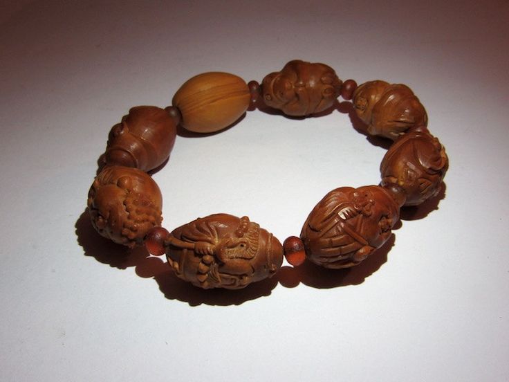 "This bracelet is made with hand carved seed beads representing taoist figures and animals. On the back of one seed it is write probably the artist signature. Period: half 20th century. Back to \"Bracelets\" section: https: https://www.etsy.com/shop/ArteOrientaleBologna?ref=hdr_shop_menu&section_id=18796442 Back to my shop: https://www.etsy.com/shop/ArteOrientaleBologna?ref=hdr_shop_menu" Adjustable Carved Beaded Bracelets For Spiritual Style, Traditional Beaded Bracelets For Good Luck, Traditional Hand-strung Stretch Bracelet, Adjustable Carved Bracelets With Round Beads, Traditional Carved Beaded Bracelets As Gift, Adjustable Carved Beaded Spiritual Bracelets, Traditional Carved Beaded Bracelets For Gift, Traditional Adjustable Carved Bracelets, Spiritual Carved Round Bracelets