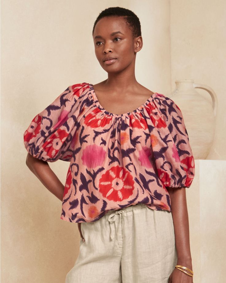 A quick-change artist, this bold top has an adjustable neckline so you can wear it as a scoop during the day and off the shoulder at night. It's woven in a blend of cotton and silk, has an oversized print, and features puff sleeves and a slightly shortened length for flattering proportions.  From Velvet by Graham & Spencer. Elastic neckline; wear as a scoop neck or off the shoulder. Elbow-length raglan puff sleeves with elastic cuffs. Bohemian Billowy Top With Blouson Sleeves, Bohemian Puff Sleeve Tops For Gatherings, Billowy Puff Sleeve Bohemian Top, Bohemian Billowy Puff Sleeve Top, Bohemian Puff Sleeve Billowy Tops, Bohemian Flowy Top With Puff Sleeves, Spring Cotton Ikat Print Top, Billowy Bohemian Floral Print Tops, Summer Peasant Top With Gathered Sleeves