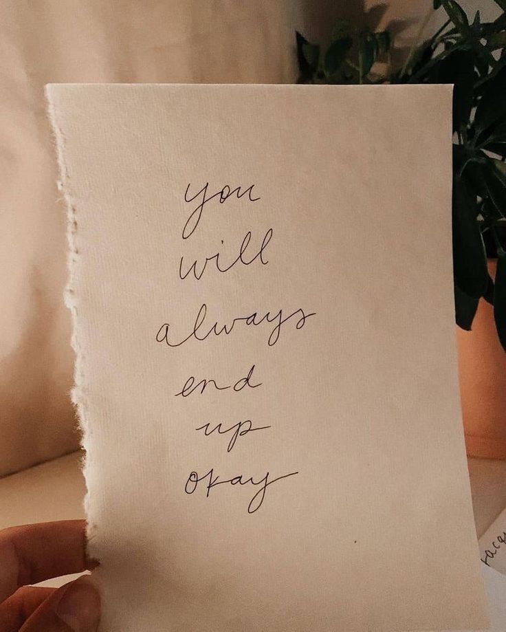 someone holding up a piece of paper that says you will always end up okay