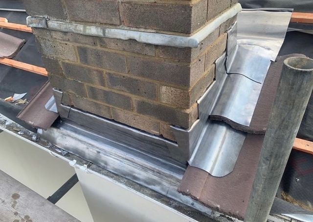 a chimney being installed on top of a building