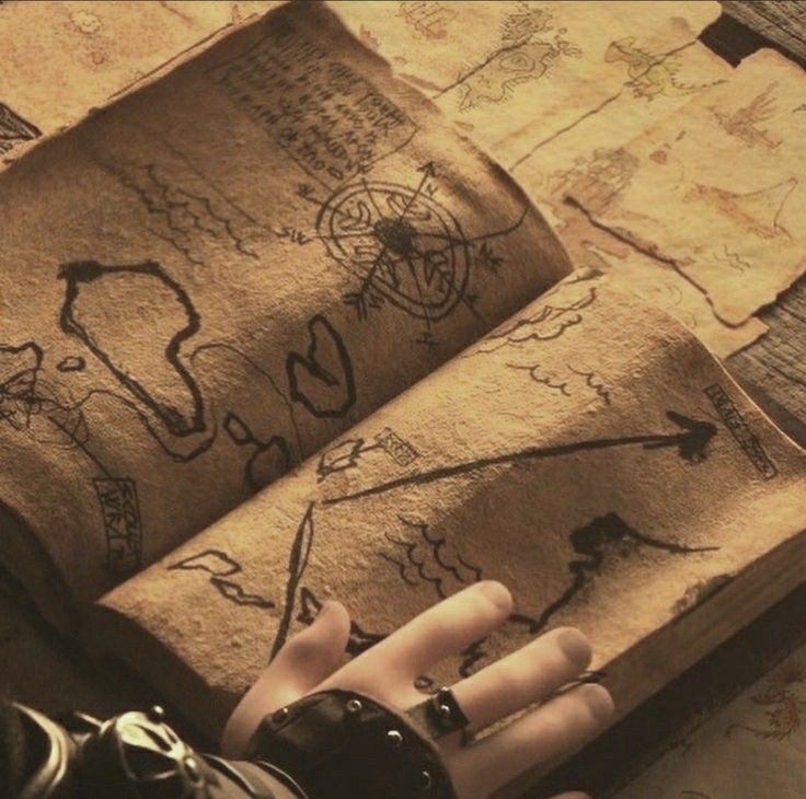 a person with their hand on an old book that has been drawn onto the pages