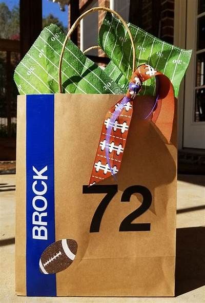 a brown paper bag with the number 72 on it and a football tie tied to it