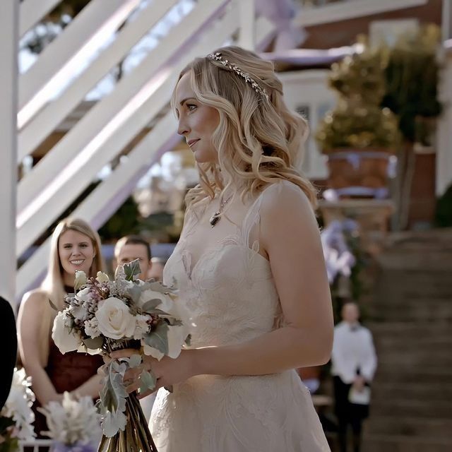 a woman in a wedding dress holding a bouquet