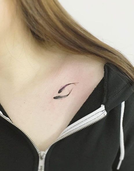 a woman with a small tattoo on her neck