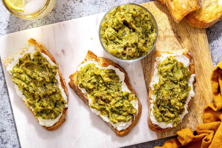 three pieces of bread with guacamole spread on them