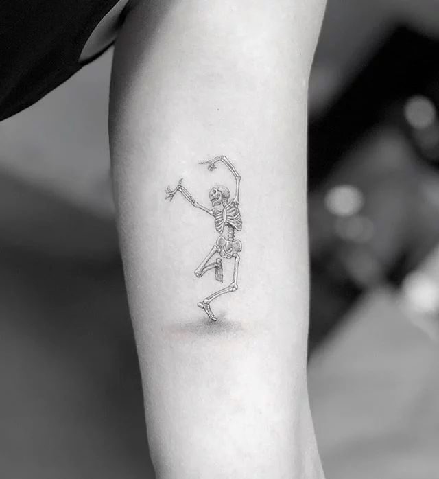 a person with a skeleton tattoo on their arm