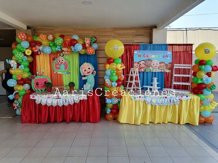 there are balloons and decorations on the floor in front of this party setup for a children's birthday