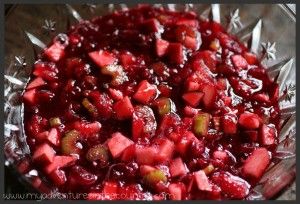 a bowl filled with cranberry sauce on top of a table