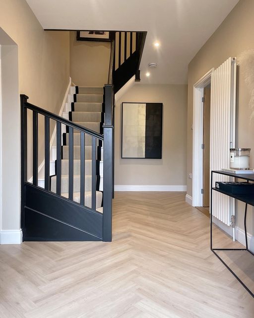 an image of a house with stairs and wood flooring on the bottom level in this photo